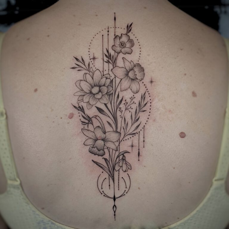 geometric and flower feminine backpiece tattoo by Marloes Lupker